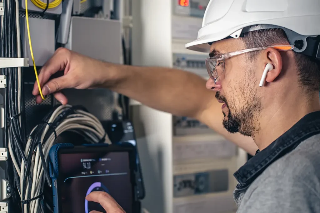 Smart Hands Tech working in a telecom closet.