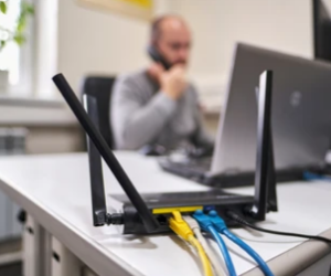 Image of Wireless Router with Cabling on Desk In Office